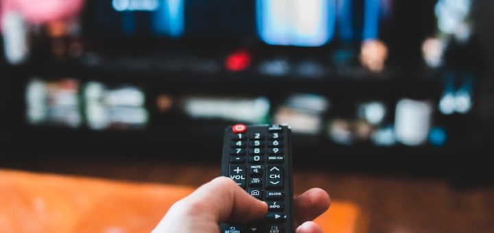 person holding black remote control